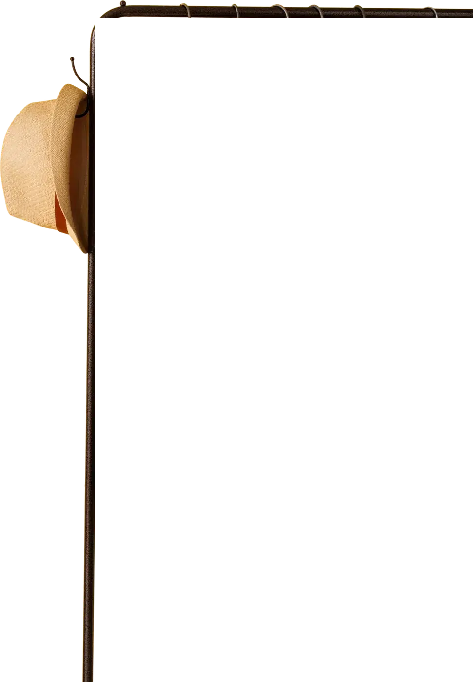 Printed shirts on a clothing rail, with a straw hat on the hook